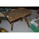 A rustic burr elm three legged stool