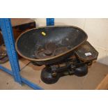 A set of cast iron kitchen scales and weights by Y