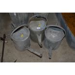 Three vintage galvanised watering cans