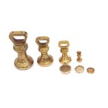 A collection of Avery brass weights