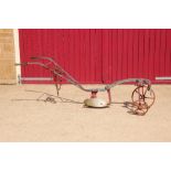A small horse drawn single furrow plough