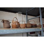 A wicker fishing basket and five various wicker ba