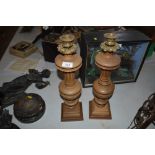 A pair of wooden baluster candlesticks with gilt m