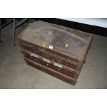 An old canvas and battened domed travelling trunk