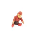 A vintage toy monkey wearing a fez