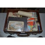 A suitcase containing various ephemera, postcards