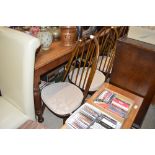 A set of four Ercol stick back dining chairs