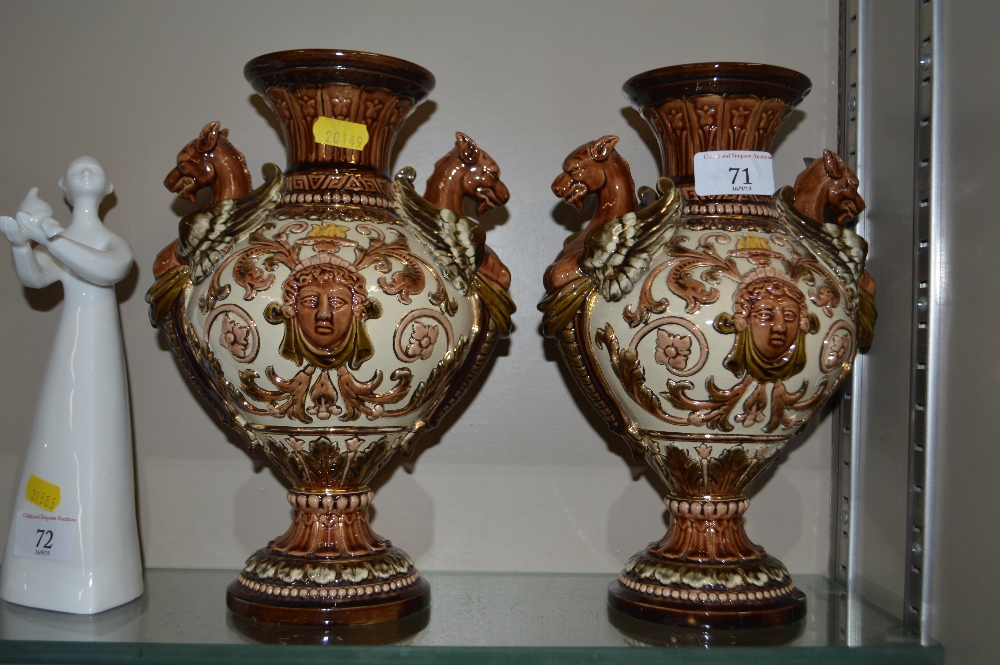 A pair of Majolica style twin handled vases