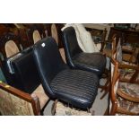 A pair of chrome and leather upholstered swivel hi