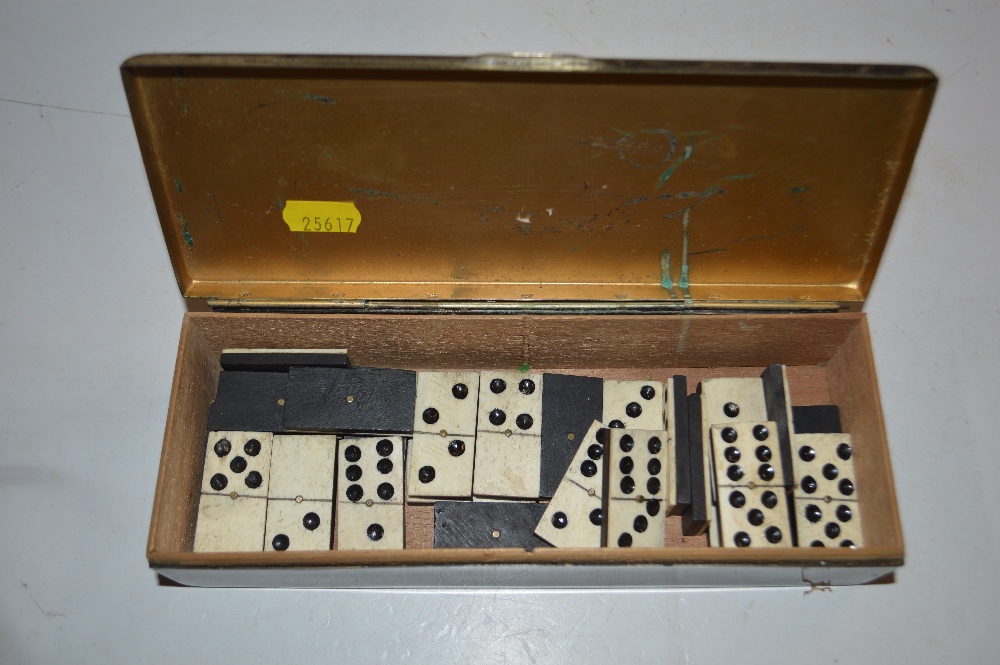 A silver plated box and contents of antique domino