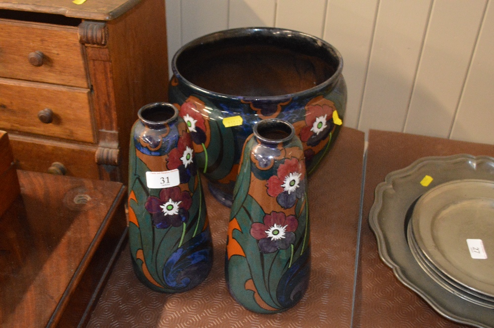 A pottery floral decorated jardiniere; together wi