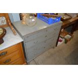 A grey painted chest fitted four long drawers