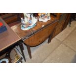 An antique oak drop leaf table