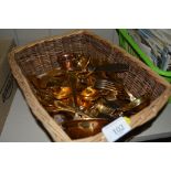 A wicker basket of gold plated cutlery