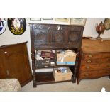 An antique oak panelled cupboard with drop front,