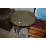 An Eastern brass tray topped occasional table