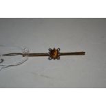 A 9ct gold pearl and tigers eye set bar brooch