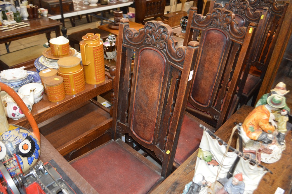 A set of four 1930's oak framed and leather uphols