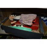 A box containing a two headed doll; a wooden puzzl