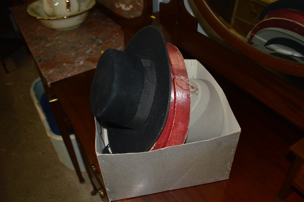 A collapsible top hat; one other top hat etc.