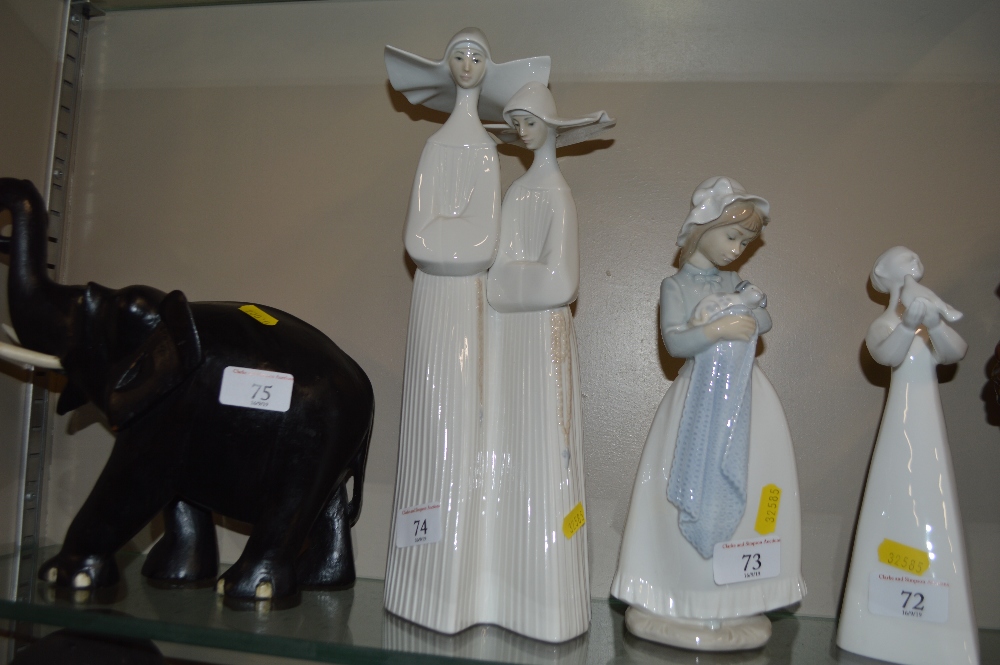 A Lladro figurine in the form of two nuns