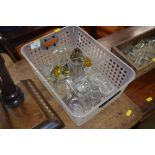 A basket of glass inkwells, salt cellars etc.