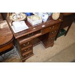 A reproduction mahogany kneehole writing desk