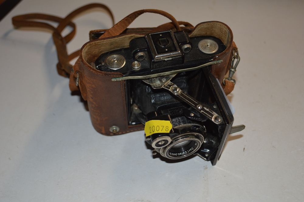 A Zeiss Ikon camera with leather carrying case