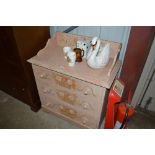 A painted pine three drawer chest