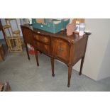 A reproduction serpentine mahogany sideboard