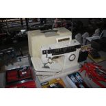 A Singer electric sewing machine with fitted case-