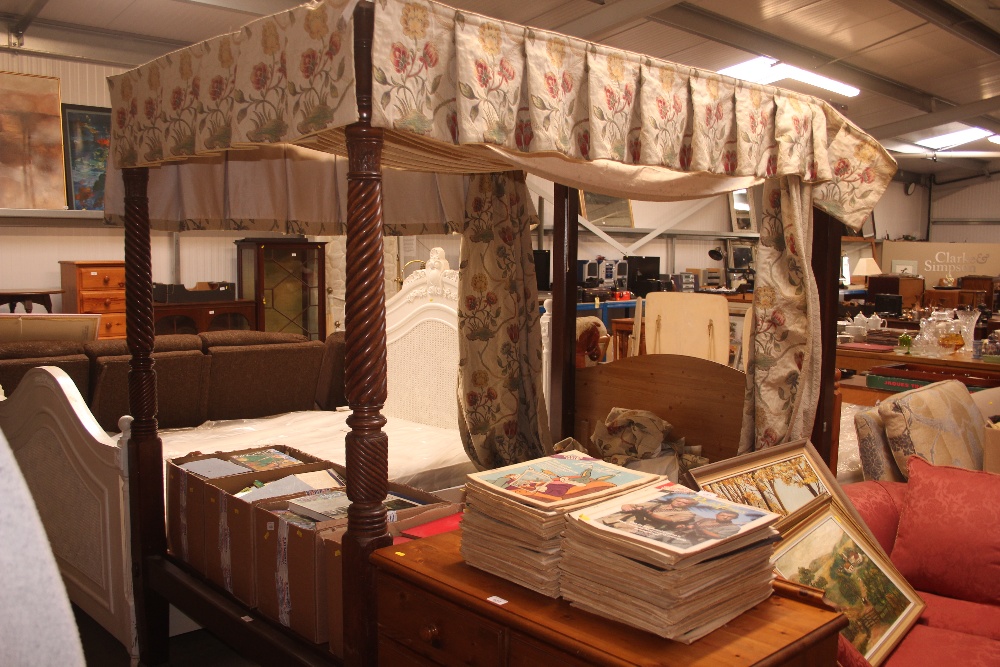 A four poster bed with drapes