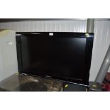 A Panasonic flat screen TV with remote control