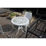 A metal garden table with one matching chair