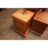 A pine bedside chest fitted three drawers