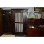 A stained pine cupboard fitted single drawer below