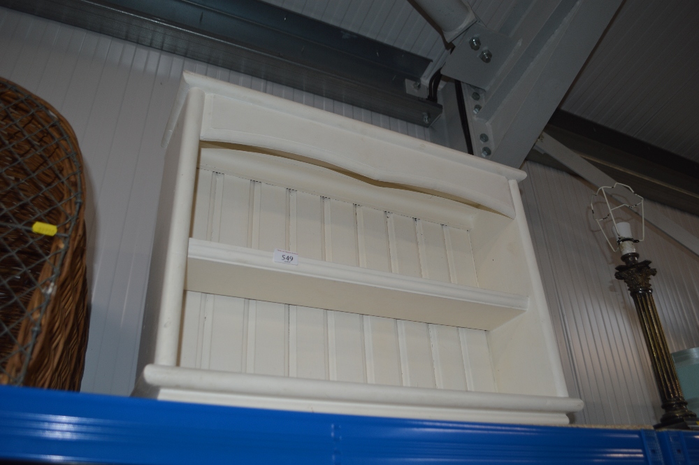 A white painted open fronted bookcase