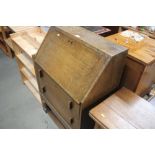 An oak bureau fitted two drawers