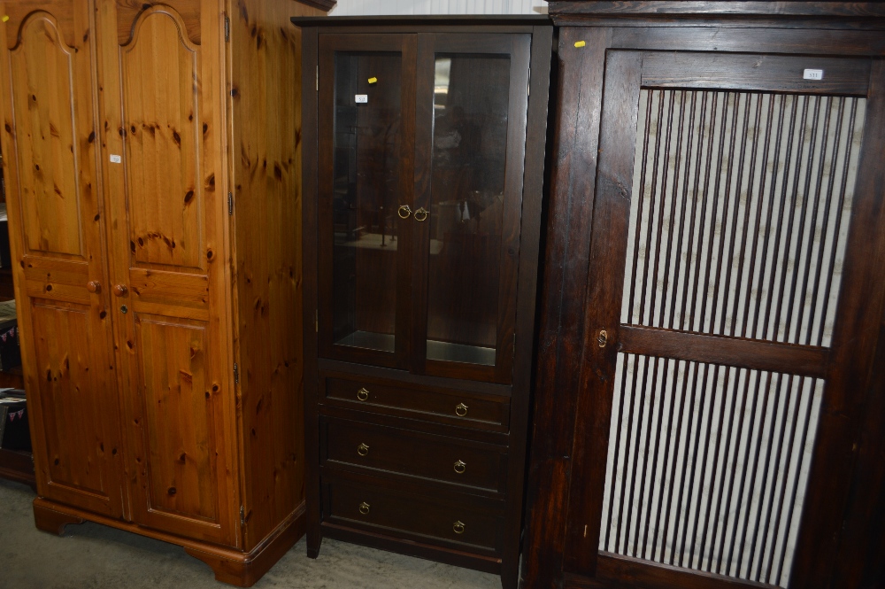 A display cabinet fitted three drawers below