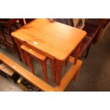 A nest of three pine occasional tables