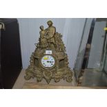 A brass cased mantle clock