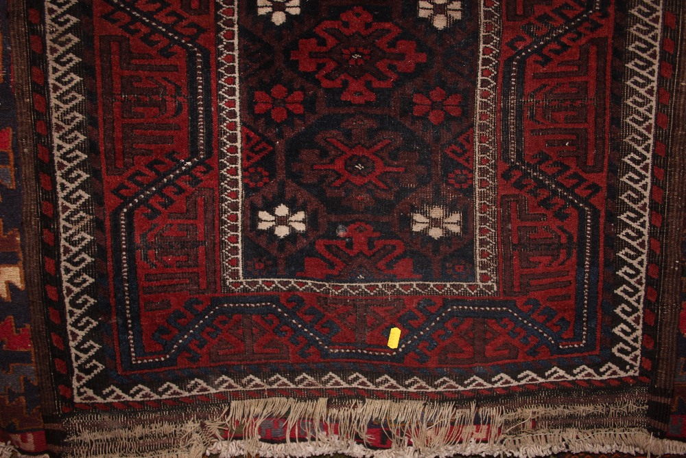 An approximate 5'5" x 2'7" red patterned rug; toge