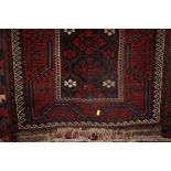An approximate 5'5" x 2'7" red patterned rug; toge