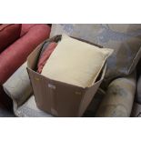 A box of various cushions, blankets etc.