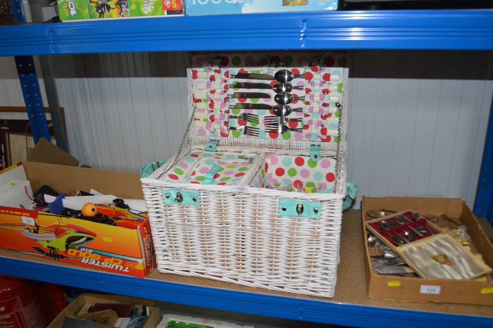 A wicker picnic hamper and contents