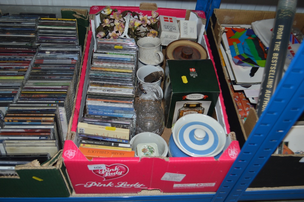 A box containing various CDs; storage jars; floral