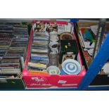 A box containing various CDs; storage jars; floral