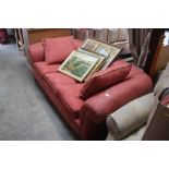 A red floral upholstered Chesterfield style settee