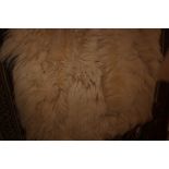 An approximate 5'4" x 2'2" sheepskin rug