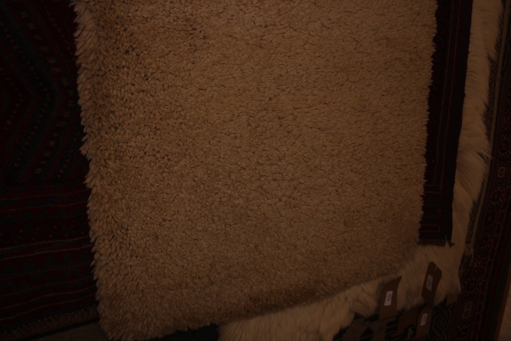 An approximate 5'2" x 2'4" wool rug
